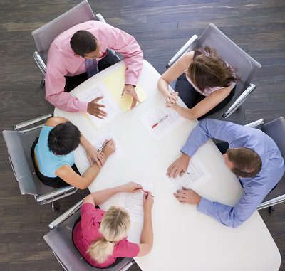 Five businesspeople at boardroom table
